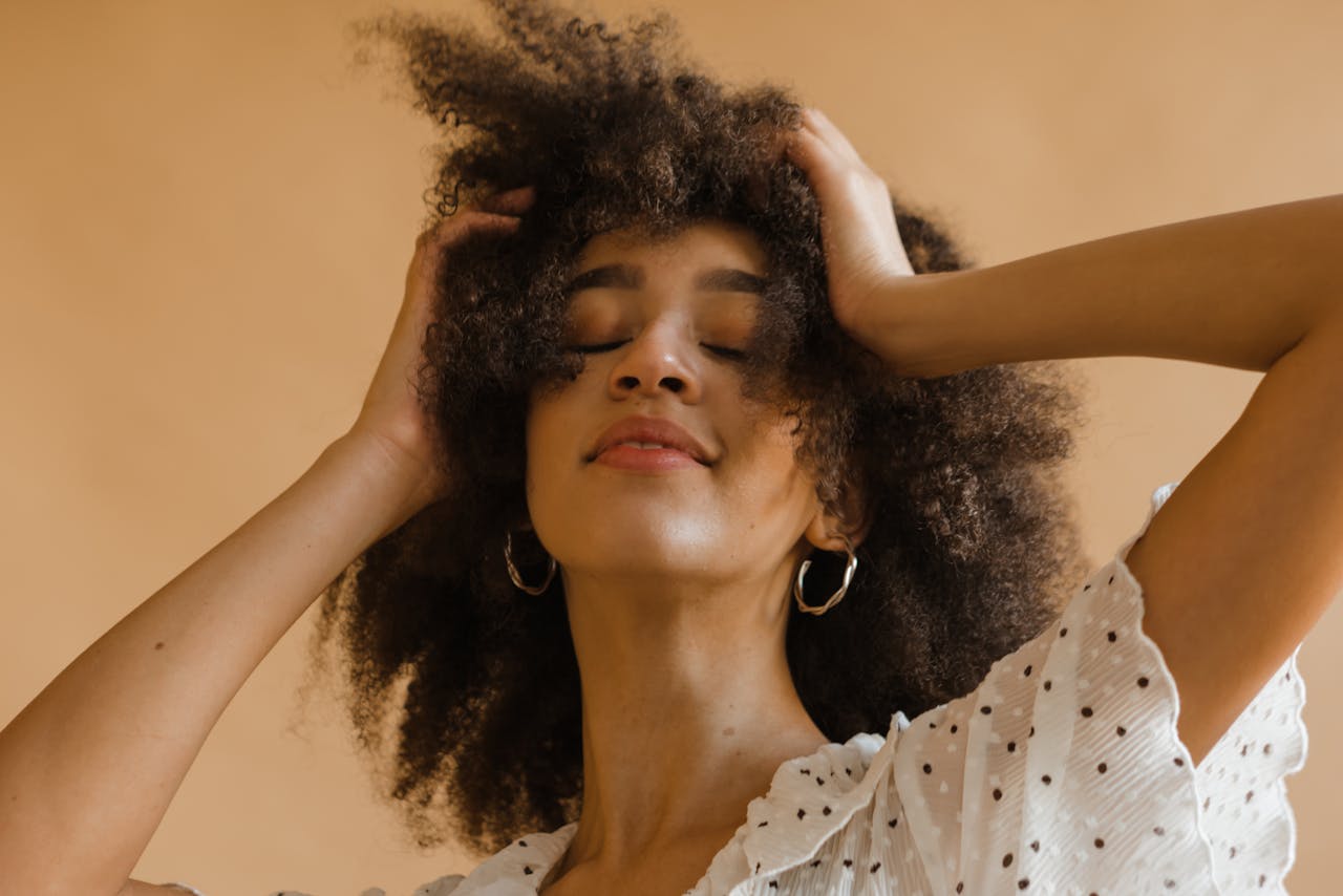 Portrait of a confident woman with natural curly hair, exuding empowerment and elegance.